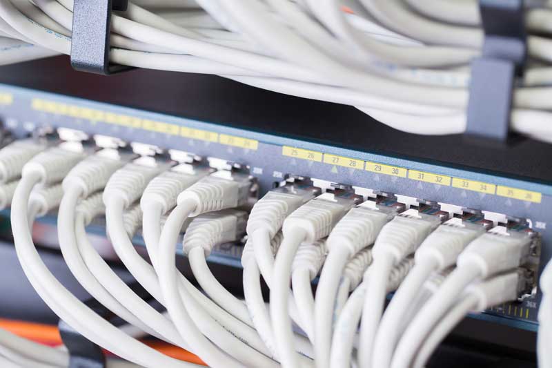 gigabit network switch with aligned patch cables in datacenter SBI 333486227